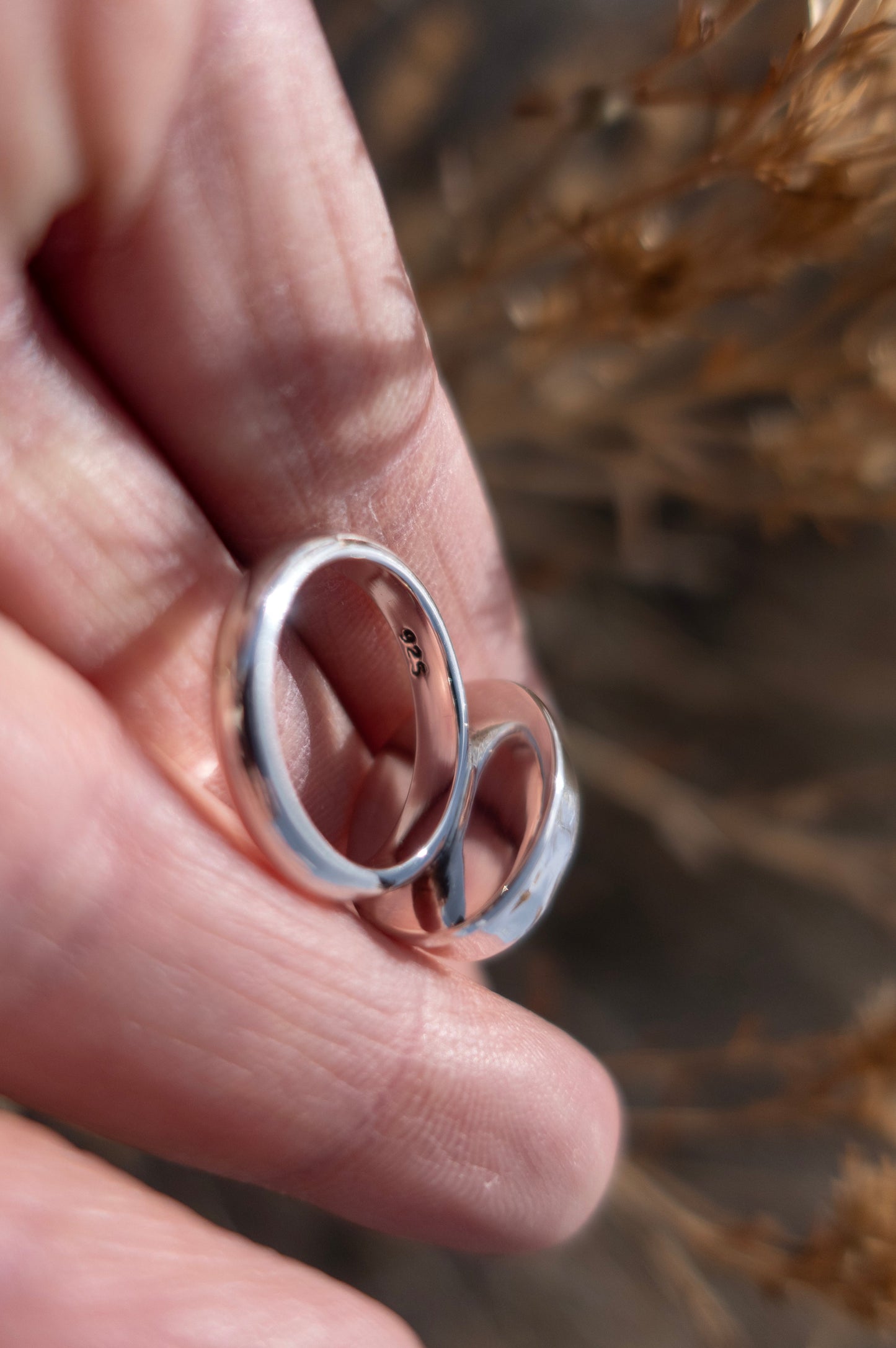 The inside of a sterling silver ring with a half round band that is stamped .925