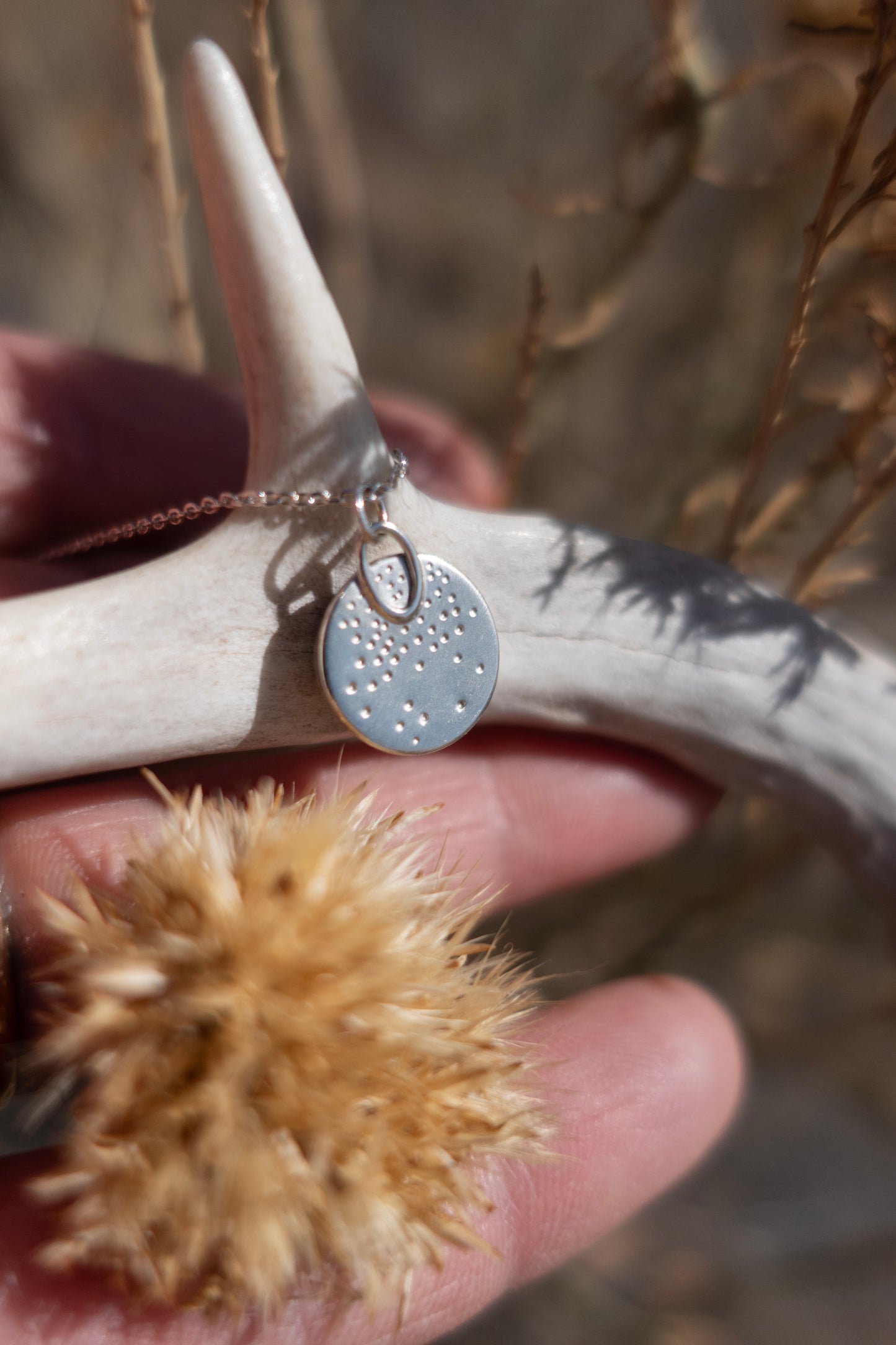 Handmade details on the back of the charm necklace