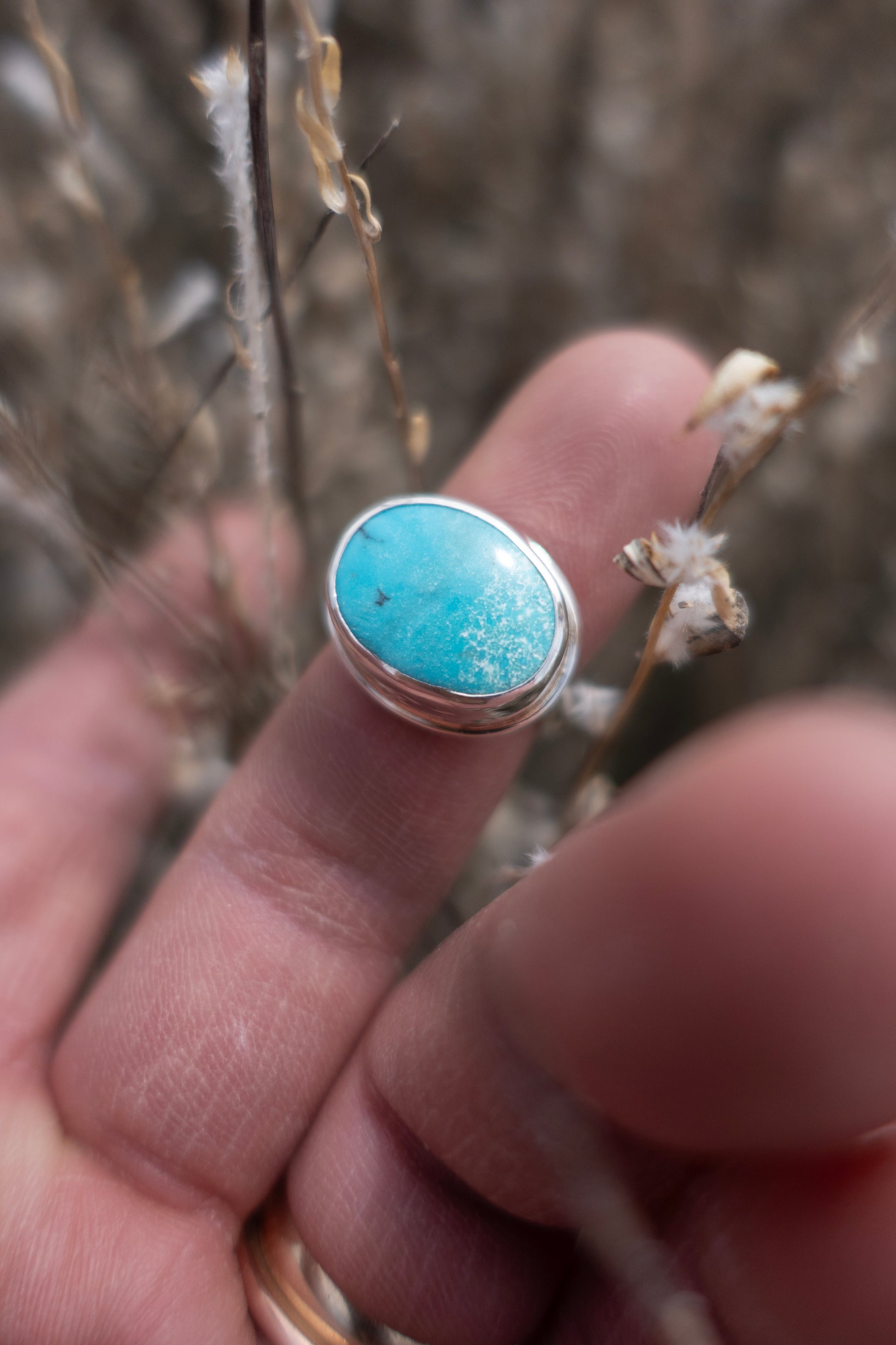 Pretty blue turquoise ring on a finger 